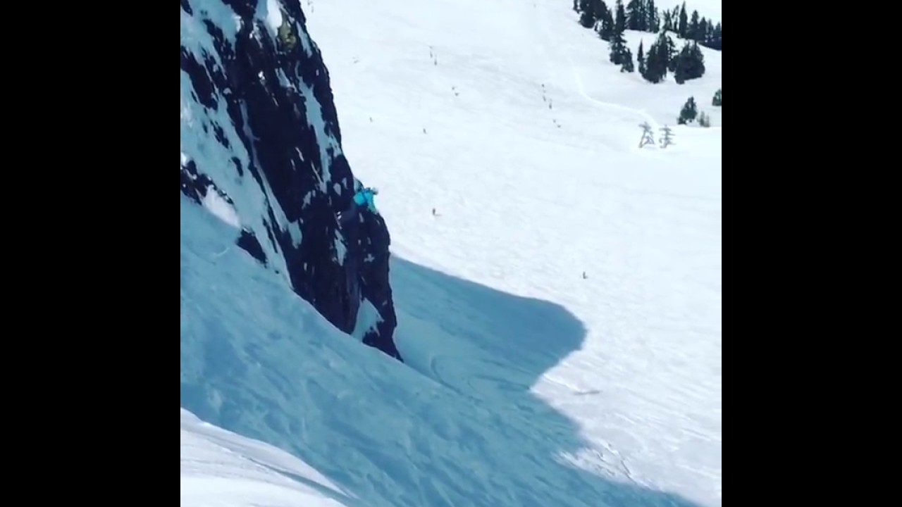 Skier backflips off a cliff