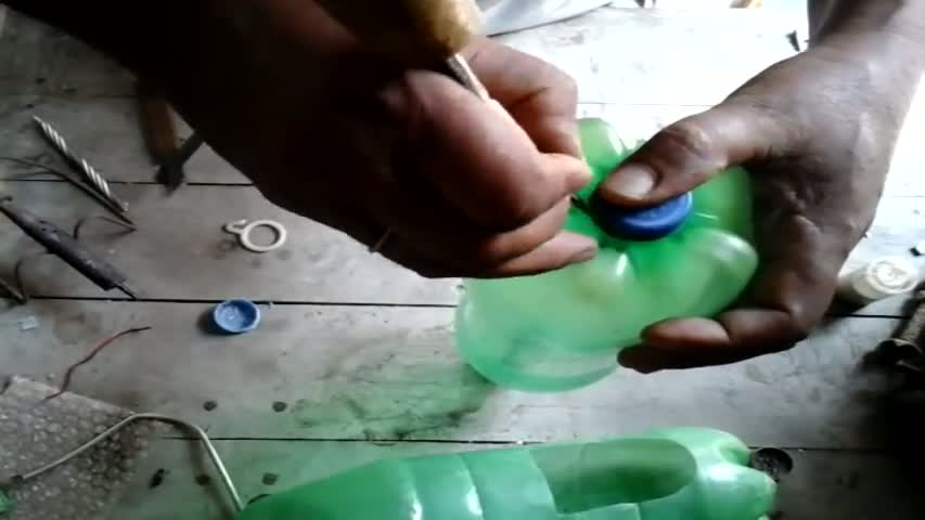 Tree planting in hanging bottles on wall 