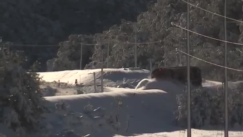 Train Driving Through Half Snow